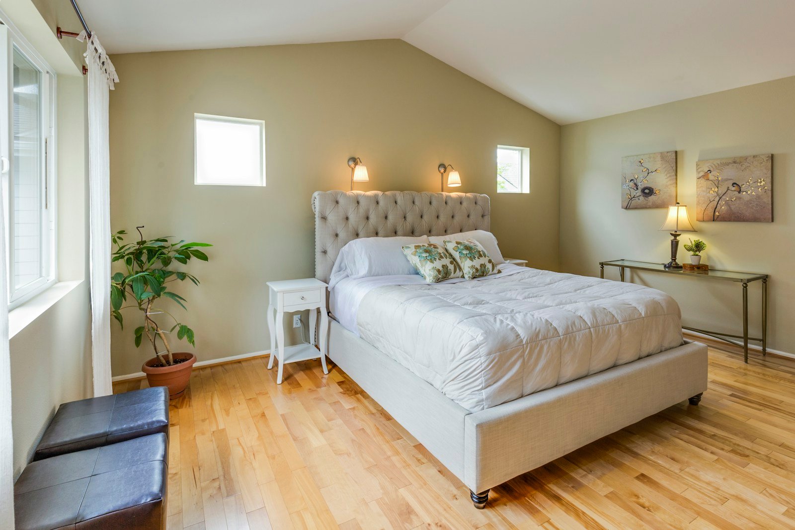 Tidy bright bedroom with made bed
